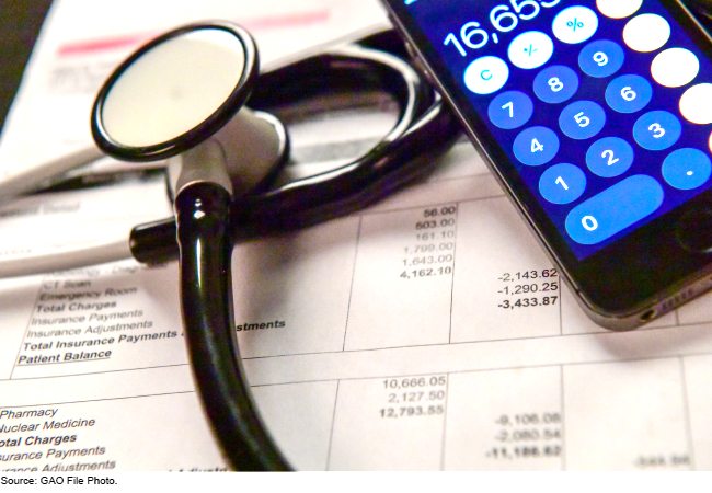 Image showing a stethoscope and phone with the calculator app open sitting on top of a spreadsheet that has payments on it.