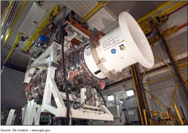 A photograph of an aircraft engine prototype in a test facility. 