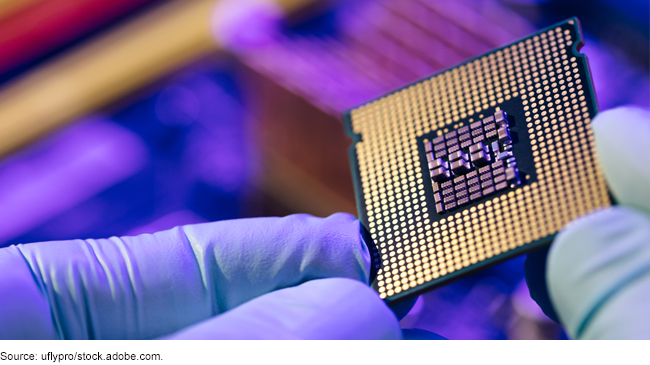 Image of a person holding a semiconductor (or chip).