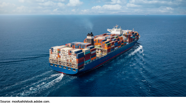 A ship on the ocean carrying many shipping containers.