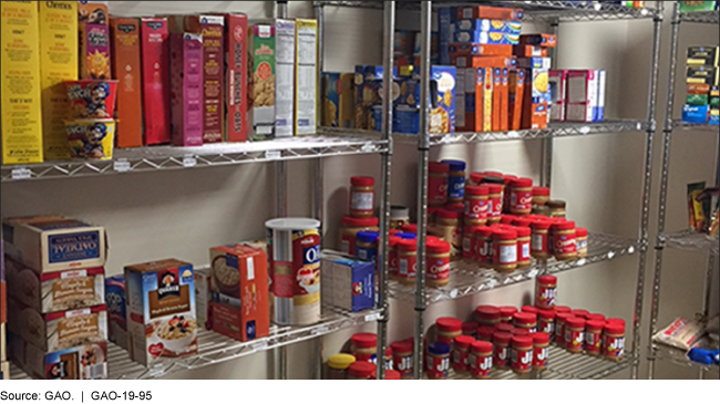 Photo of metal shelf with non-perishable items like cereal and peanut butter.