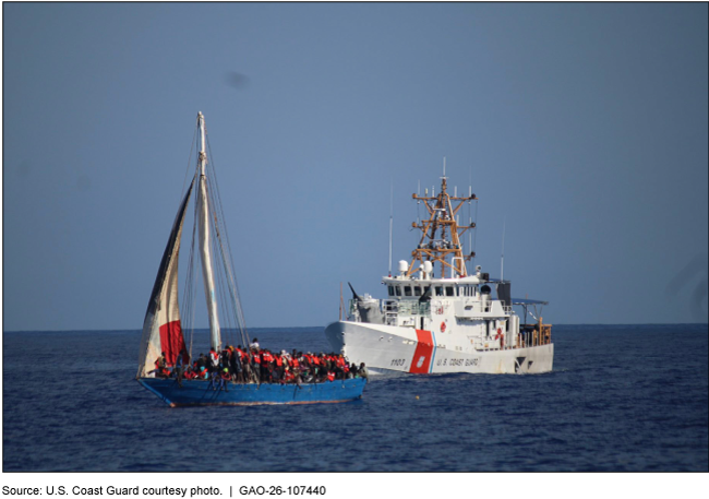 A Coast Guard ship is following closely behind a blue wooden sailboat that is overloaded with migrants about 20 miles off the coast of Haiti. The Coast Guard is preparing to intercept the sailboat and return those on board to Haiti. The photo was taken in January 2023. A Coast Guard ship is following closely behind a blue wooden sailboat that is overloaded with migrants about 20 miles off the coast of Haiti. The Coast Guard is preparing to intercept the sailboat and return those on board to Haiti. The photo was taken in January 2023.
