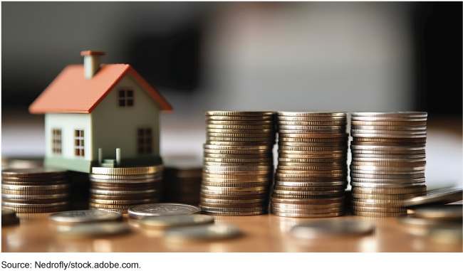 Stock image of a house and coins. Stock image of a house and coins.