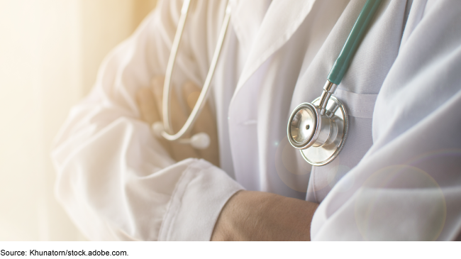 Person in white coat with stethoscope around their neck. Person in white coat with stethoscope around their neck.