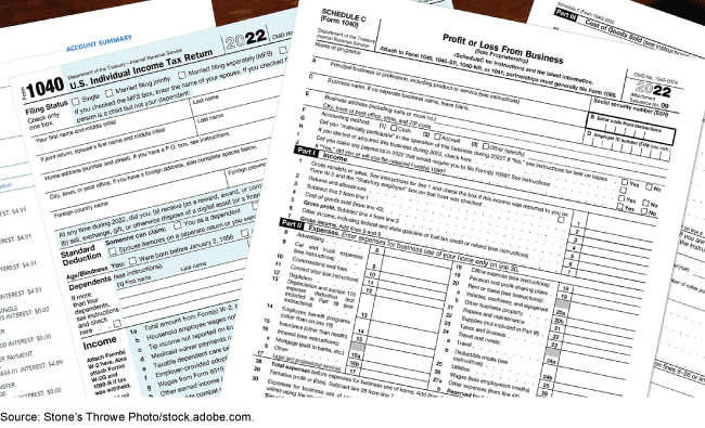 An image of income tax forms on a desk. 