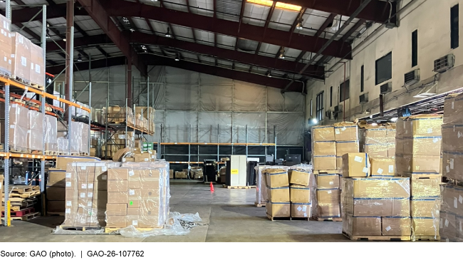 The inside of a cargo warehouse with boxes on pallets stacked on the floor and on shelves. The inside of a cargo warehouse with boxes on pallets stacked on the floor and on shelves.
