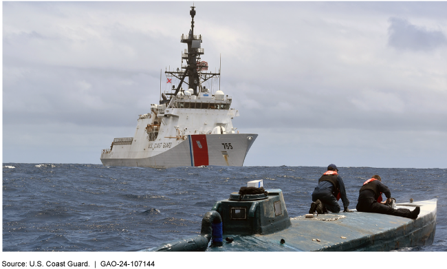 Photo showing a Coast Guard ship in the background approaching another vessel in the foreground. 