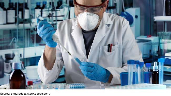 Researcher pipetting test tube to take samples in research laboratory Researcher pipetting test tube to take samples in research laboratory