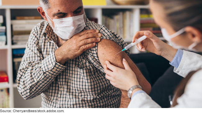 Man in a mask getting a vaccine