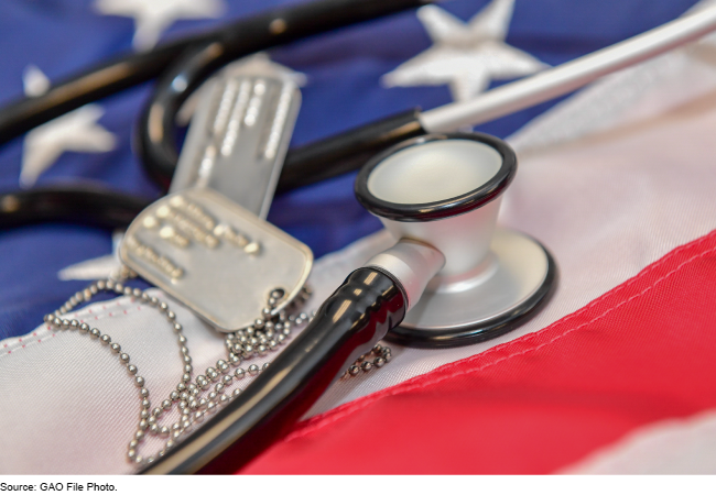 A stethoscope and military dog tags on a U.S. flag.