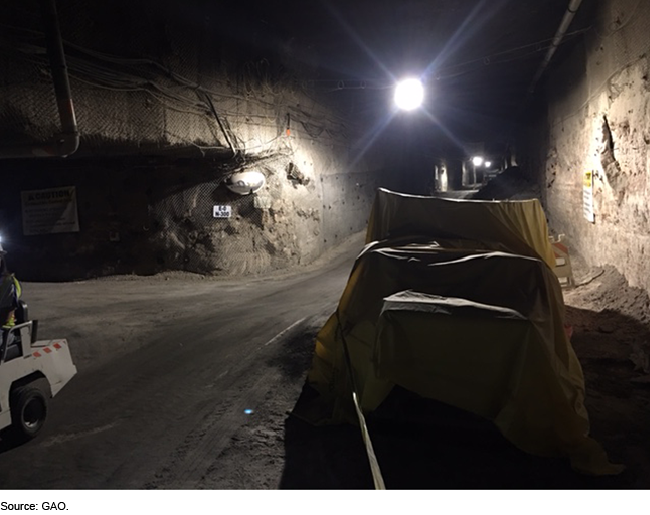 An underground tunnel with lights on the ceiling