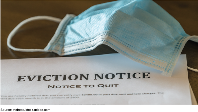 A blue medical mask on an eviction notice.