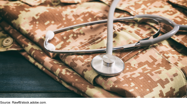 A stethoscope on top of a military uniform.