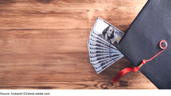 Graduation cap with money underneath it.