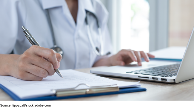 doctor writing notes from their computer