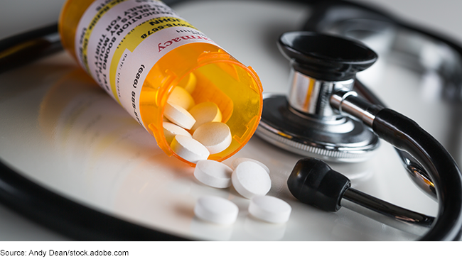 Non-proprietary prescription medication bottle and spilled pills with a stethoscope. Non-proprietary prescription medication bottle and spilled pills with a stethoscope.