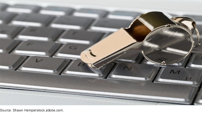 A whistle on top of a keyboard.