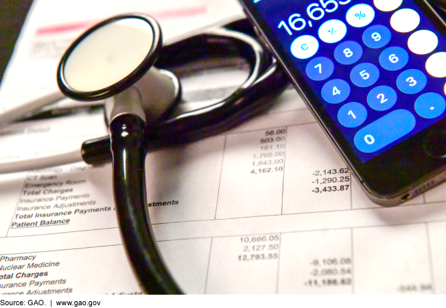 Stethoscope, calculator, medical bill