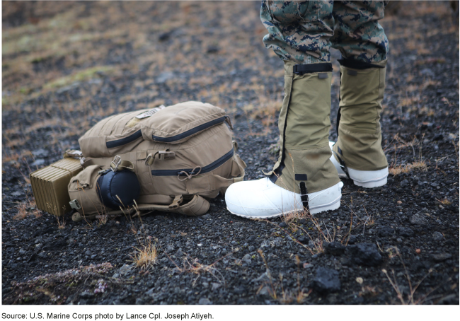 close up of the feet of a person outside and wearing a uniform and rubber boots with covers over them.