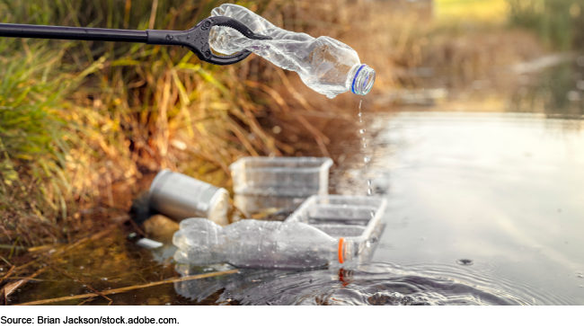 Plastic bottles and containers in a lake.