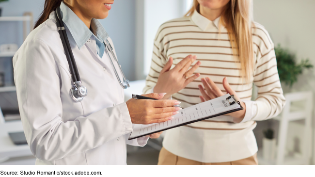 A physician consulting with a patient A physician consulting with a patient