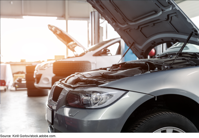 An image of cars inside a repair shop.