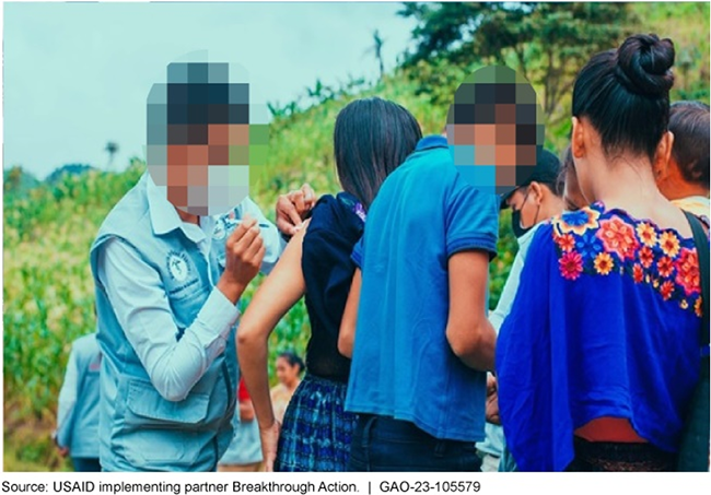 Photo showing USAID staff providing vaccinations to people in Guatemala. 