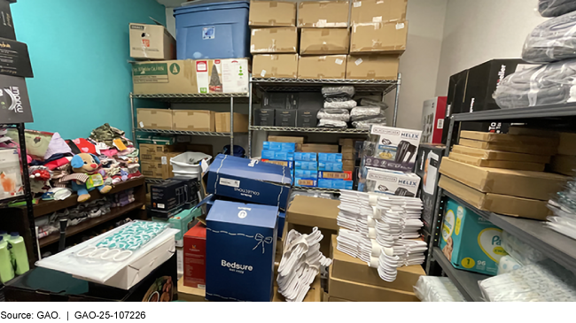 A small room filled with boxes, diapers, hangers, and more.