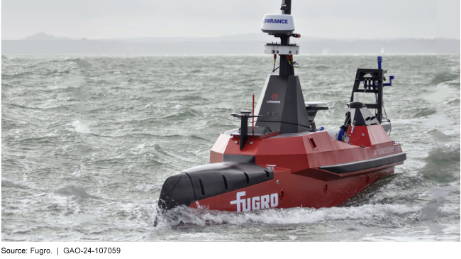 Red autonomous ship in body of water.