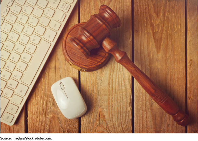 Gavel next to a computer mouse and keyboard.