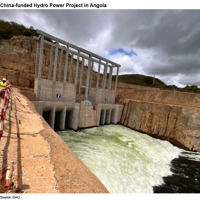 Photo showing a hydro power project in Angola--looks like a damn with water pushing through it.