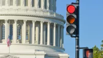 Photo showing the Capitol dome in the background and a stop light in the foreground. 