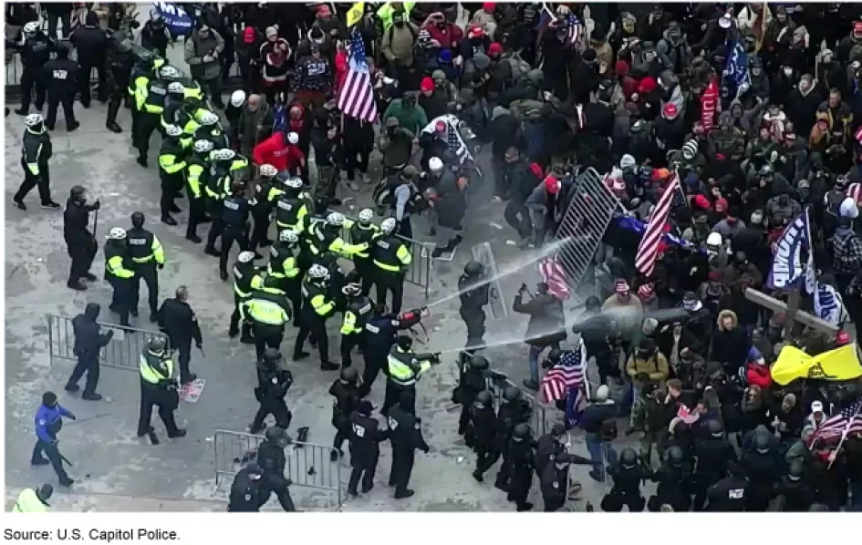 Photo showing police tryin to push back rioters at the Capitol