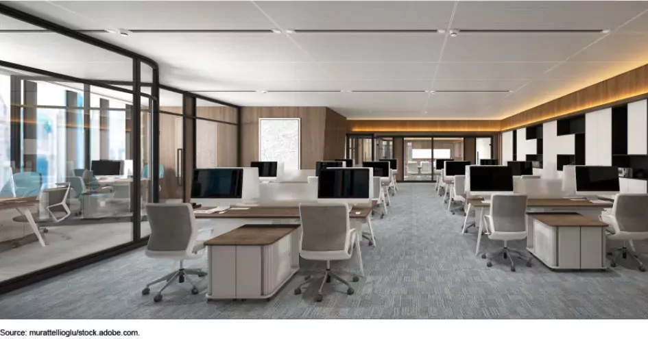 Photo showing an office space with desks and chairs, but not employees