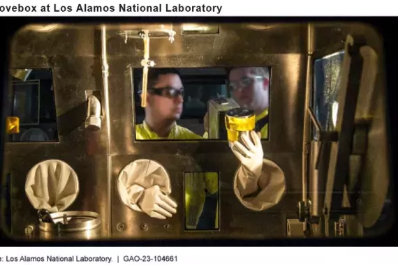 A photo showing a person using a glovebox at a plutonium facility at Los Alamos National Laboratory